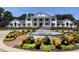 Stunning home exterior featuring a fountain, manicured landscaping, and classic architectural design at 89 Gleneagle Ln., Pawleys Island, SC 29585