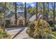 Elegant brick home with a circular driveway and meticulously landscaped front yard, creating a welcoming entrance at 89 Gleneagle Ln., Pawleys Island, SC 29585