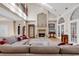 Inviting living room featuring a soaring ceiling, fireplace, hardwood floors, and arched windows at 89 Gleneagle Ln., Pawleys Island, SC 29585