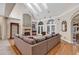 Spacious living room with a fireplace, hardwood floors, and large windows offering ample natural light at 89 Gleneagle Ln., Pawleys Island, SC 29585