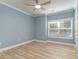 Bright bedroom with wood-look floors, ceiling fan, and a large window at 2073 Silver Crest Dr. # 4 D, Myrtle Beach, SC 29579