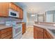 Open kitchen with breakfast bar overlooking the dining area featuring white appliances at 2073 Silver Crest Dr. # 4 D, Myrtle Beach, SC 29579