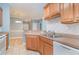 Well-lit kitchen featuring light wood cabinets, stainless steel sink, and beige backsplash at 2073 Silver Crest Dr. # 4 D, Myrtle Beach, SC 29579