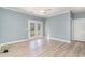 Bright living room featuring light blue walls, white trim, modern flooring, and glass patio doors at 2073 Silver Crest Dr. # 4 D, Myrtle Beach, SC 29579