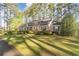 Side exterior view of a brick home showcasing its well-manicured lawn and shrubbery at 2807 Graham Rd., Conway, SC 29526