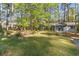 Charming single-story home featuring a lovely landscaped front yard, patio area, and mature trees at 2807 Graham Rd., Conway, SC 29526
