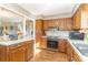 Classic kitchen with oak cabinets, light countertops, and modern appliances at 2807 Graham Rd., Conway, SC 29526