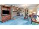 Cozy living room with a brick fireplace, vintage accents, and blue carpeting at 2807 Graham Rd., Conway, SC 29526