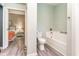 This bathroom features a white toilet, tub, and modern fixtures with access to a nearby bedroom at 4426 Old Kings Hwy., Murrells Inlet, SC 29576