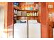 Convenient laundry room featuring a washer, dryer, and wooden shelving at 4426 Old Kings Hwy., Murrells Inlet, SC 29576