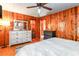 Spacious main bedroom featuring wood paneled walls and a large dresser with mirror at 4426 Old Kings Hwy., Murrells Inlet, SC 29576