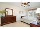 Comfortable bedroom featuring a ceiling fan, dresser, and a window for natural light at 206 Mossy Stone Ct. # 1605, Murrells Inlet, SC 29576