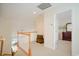 Open hallway with view of stairs, decorative chest and peek into bedroom at 206 Mossy Stone Ct. # 1605, Murrells Inlet, SC 29576