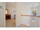 Upstairs hallway with wood railing and a bedroom featuring classic wood furniture at 206 Mossy Stone Ct. # 1605, Murrells Inlet, SC 29576