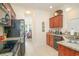 Well-appointed kitchen with granite countertops and dark wood cabinets at 206 Mossy Stone Ct. # 1605, Murrells Inlet, SC 29576