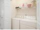 A functional laundry room with a washer, dryer, and storage shelves at 206 Mossy Stone Ct. # 1605, Murrells Inlet, SC 29576