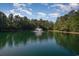 Picturesque pond view with a fountain set against a backdrop of a clear sky and lush trees at 206 Mossy Stone Ct. # 1605, Murrells Inlet, SC 29576