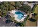 Aerial view of community pool, showcasing ample lounge seating, lush landscaping, and convenient parking for residents' enjoyment at 206 Mossy Stone Ct. # 1605, Murrells Inlet, SC 29576