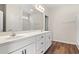 Double vanity bathroom with a large mirror and neutral colors at 315 Hayloft Circle, Conway, SC 29526