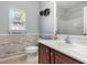 Bathroom with a wood-accent wall, vanity, and tub/shower combination at 323 Trestle Way, Conway, SC 29526