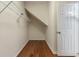 Under-stair closet with laminate flooring and wire shelving for organized storage at 323 Trestle Way, Conway, SC 29526
