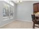 Bright breakfast nook with large window, tan tile floors, and dark wood kitchen cabinets at 323 Trestle Way, Conway, SC 29526