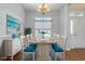 Staged dining room with hardwood floors, a dining table, decorative molding, and a chandelier at 323 Trestle Way, Conway, SC 29526