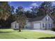 Well-maintained home exterior with a two-car garage, lush green lawn, and mature trees for privacy at 323 Trestle Way, Conway, SC 29526