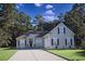 Charming single-Gathering home featuring a manicured lawn and a cozy exterior design with neutral tones and black shutters at 323 Trestle Way, Conway, SC 29526