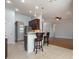 Open concept kitchen with counter seating, stainless appliances and tile flooring at 323 Trestle Way, Conway, SC 29526