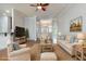 Comfortable living room with hardwood floors, a ceiling fan, neutral furnishings, and light-colored walls at 323 Trestle Way, Conway, SC 29526