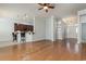 A large, light-filled living space featuring hardwood floors, opening to kitchen and foyer at 323 Trestle Way, Conway, SC 29526