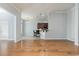 Bright open living space with hardwood floors and a view into the kitchen area at 323 Trestle Way, Conway, SC 29526