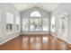 Bright sun room with hardwood floors, large windows, and a vaulted ceiling, offering ample natural light at 323 Trestle Way, Conway, SC 29526