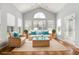 Staged sun room with vaulted ceilings, hardwood floors, neutral wicker furniture and bright blue accents at 323 Trestle Way, Conway, SC 29526