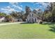 Spacious grassy yard surrounding a home with a neutral exterior and dark shutters at 323 Trestle Way, Conway, SC 29526