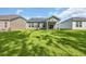 A spacious backyard with well-maintained grass and a covered patio attached to the home at 389 Sun Colony Blvd., Longs, SC 29568