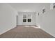 Bright bedroom with neutral carpet, trim and paint, large windows, and a door leading to the rest of the home at 389 Sun Colony Blvd., Longs, SC 29568