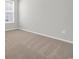 A bedroom features neutral carpet, white walls, natural light, and large window with blinds at 389 Sun Colony Blvd., Longs, SC 29568