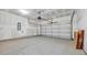 Spacious garage with concrete floor, drywall, and a white garage door at 389 Sun Colony Blvd., Longs, SC 29568