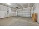 Spacious garage with concrete floor, drywall, and a white garage door at 389 Sun Colony Blvd., Longs, SC 29568