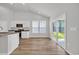 Bright kitchen featuring wood floors, granite countertops, white cabinets, and stainless steel appliances at 389 Sun Colony Blvd., Longs, SC 29568