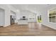 Open-concept kitchen with wood floors, stainless appliances, granite countertops, and breakfast bar for casual dining at 389 Sun Colony Blvd., Longs, SC 29568