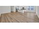 Bright, open floor plan with wood floors connecting the living room to the kitchen with granite countertops and appliances at 389 Sun Colony Blvd., Longs, SC 29568