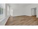 Spacious and airy living room with wood floors, neutral walls, and natural light streaming through the windows at 389 Sun Colony Blvd., Longs, SC 29568