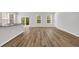 Bright living room with wood floors, neutral paint, and abundant natural light from windows and sliding glass door at 389 Sun Colony Blvd., Longs, SC 29568
