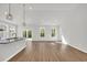 Open-concept living room featuring luxury vinyl plank flooring, recessed lighting, and abundant natural light at 389 Sun Colony Blvd., Longs, SC 29568