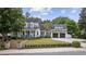 Charming two-story home featuring a well-manicured front lawn, inviting porch, and attached two-car garage at 9340 Lake Dr., Myrtle Beach, SC 29572