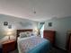 Comfortable bedroom with a cozy bed, wooden furnishings, and decor at 1101 Possum Trot Rd. # B302, North Myrtle Beach, SC 29582