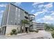 Attractive condominium with multi-level balconies and private entrances surrounded by lush landscaping at 1101 Possum Trot Rd. # B302, North Myrtle Beach, SC 29582